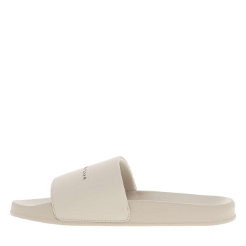 Claquettes beiges avec un talon plat et une semelle en forme cuvette